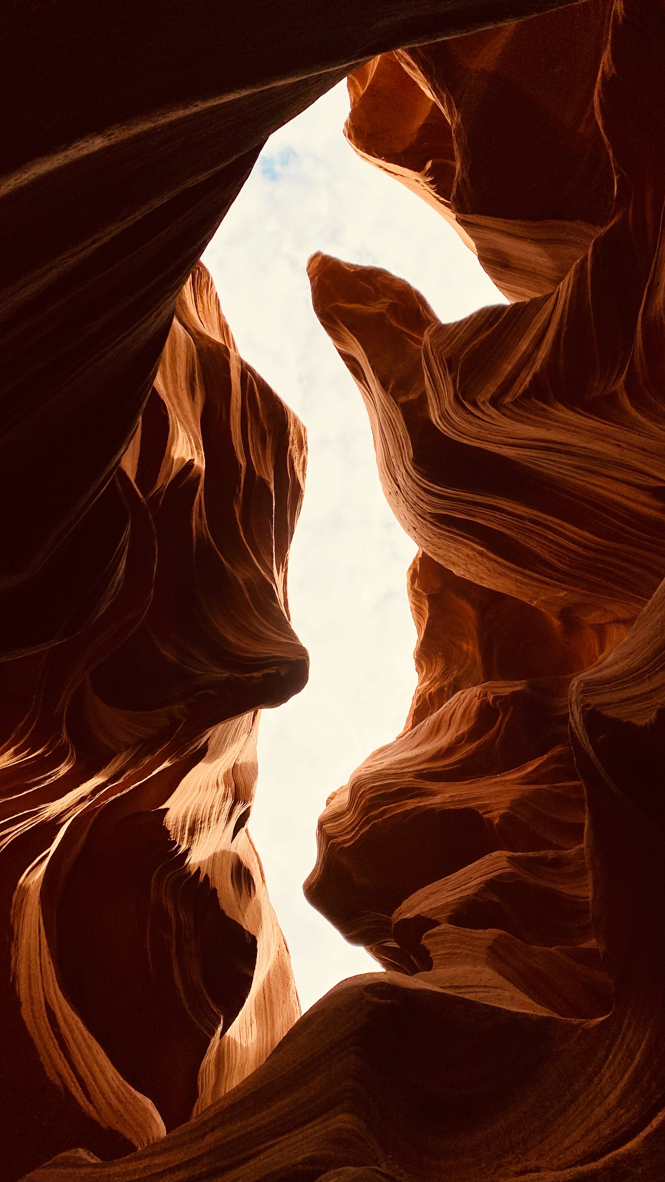 a narrow slot in the side of a rock formation