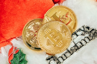 two gold bitcoins sitting next to each other