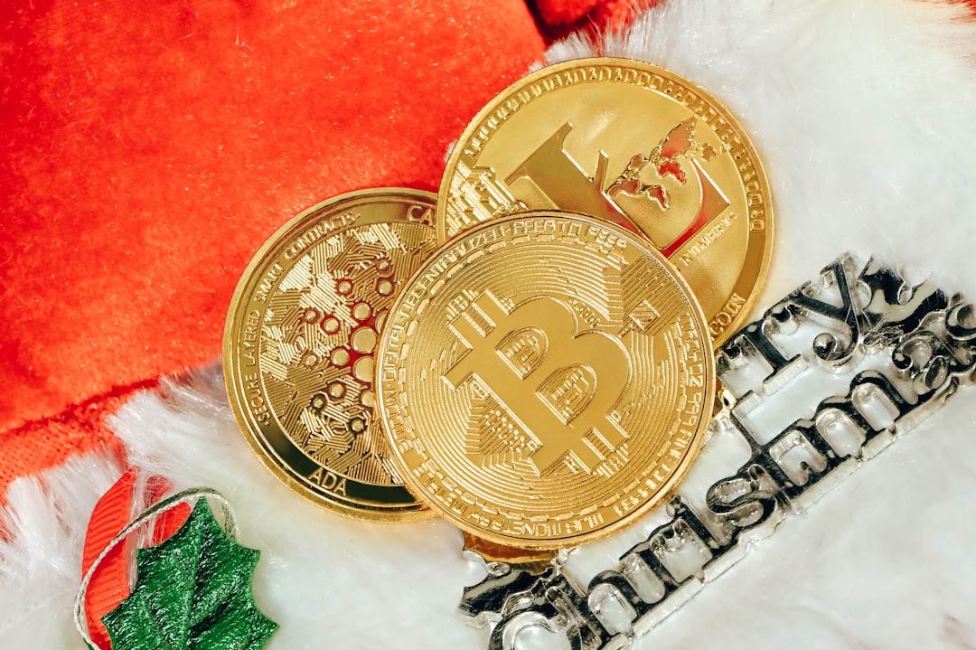 two gold bitcoins sitting next to each other, Bitcoin, Litecoin, and Cardano coin on top of a Christmas sign<p></figure>
