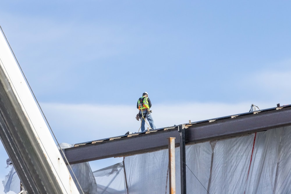 a man standing on top of a metal structure