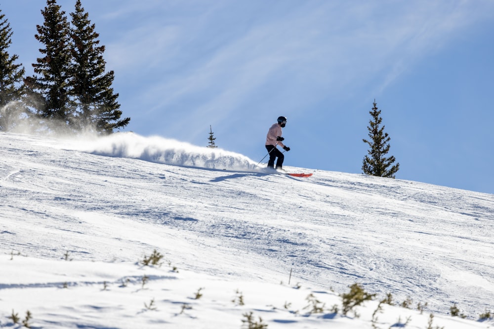 a person riding skis down a snow covered slope