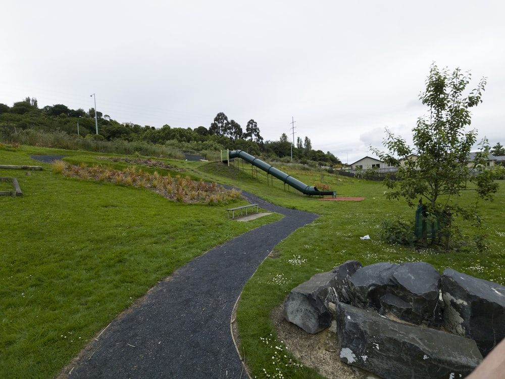 a park with a playground and a rock slide