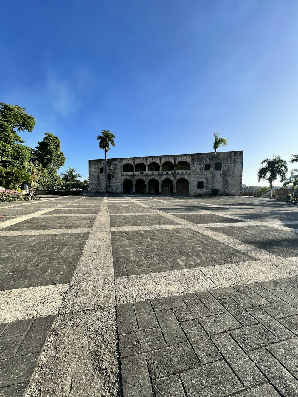 a large building with a palm tree in the background