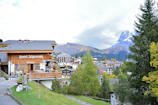 a small town with mountains in the background