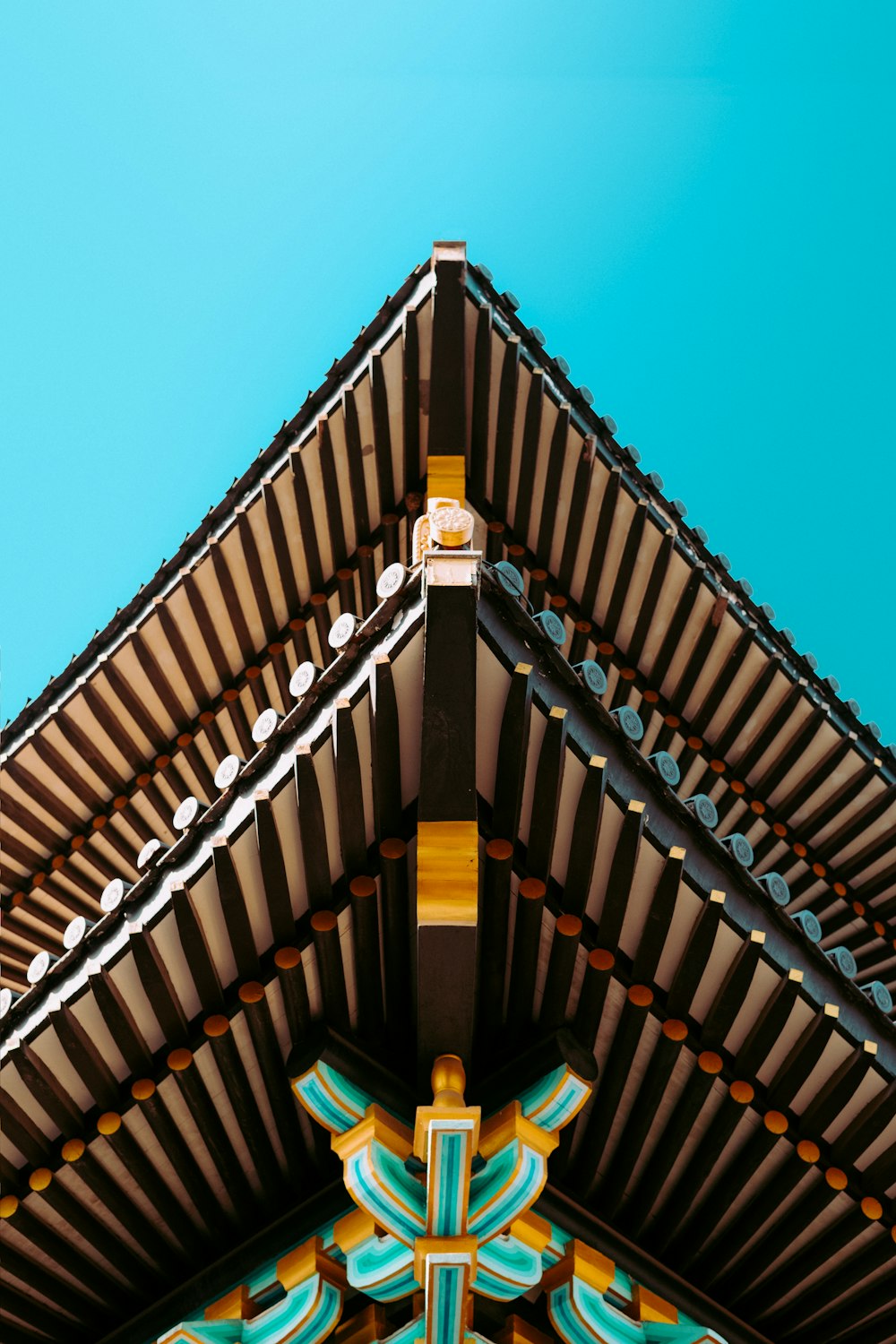 the roof of a building with a blue sky in the background