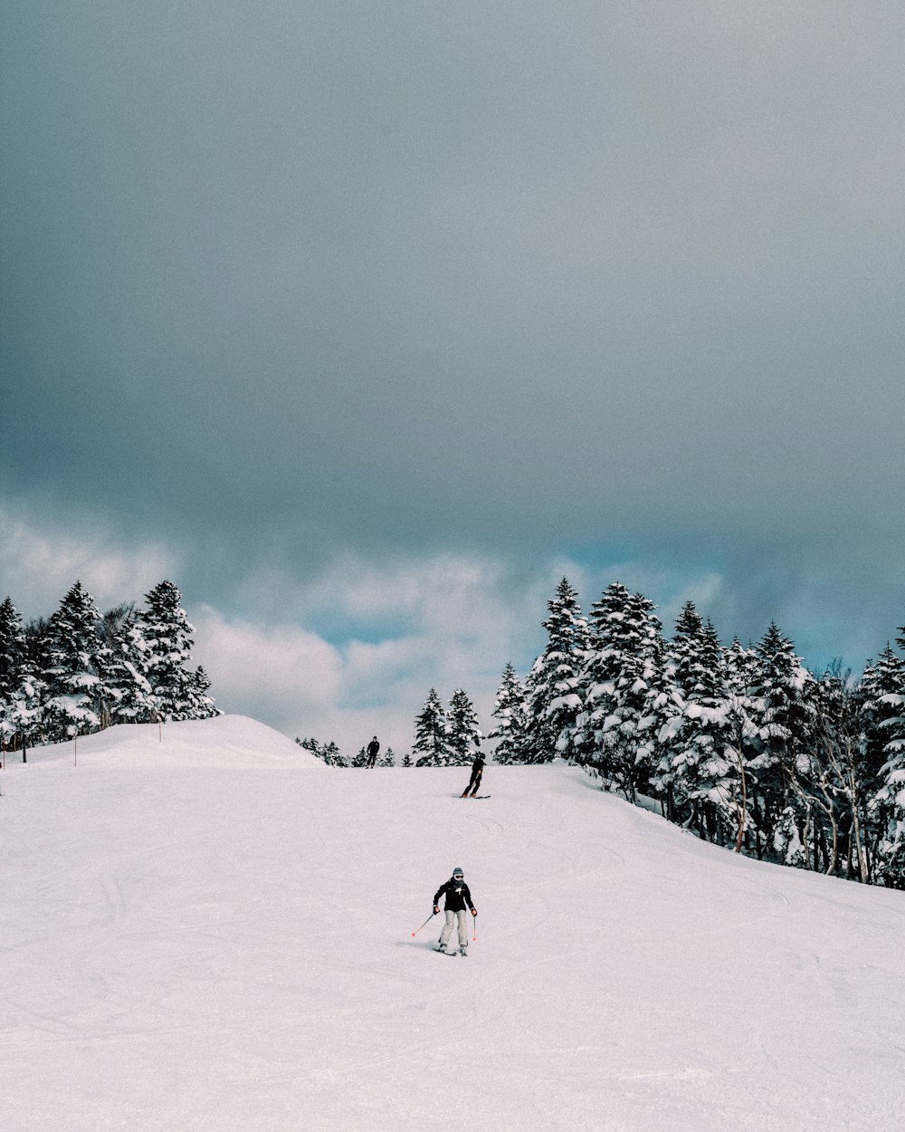 two people skiing down a snow covered slope