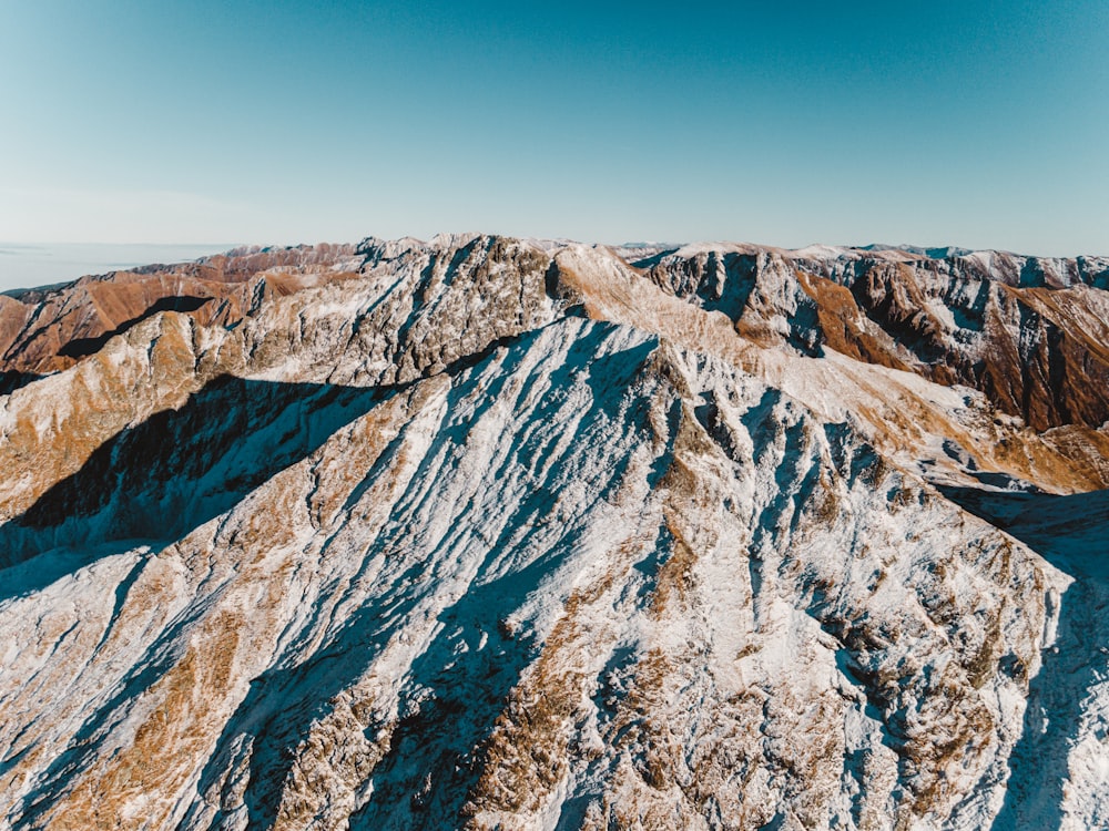 an aerial view of a snowy mountain range