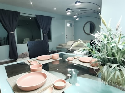 A modern dining table set with blue ceramic dishes and natural wood accents.