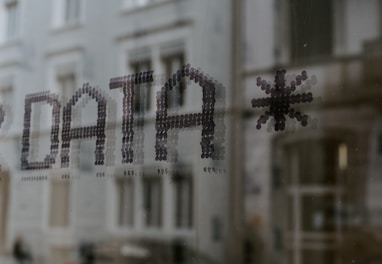 a close up of a window with a building in the background