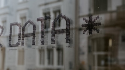 a close up of a window with a building in the background