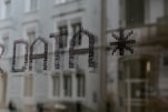 a close up of a window with a building in the background