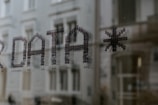 a close up of a window with a building in the background