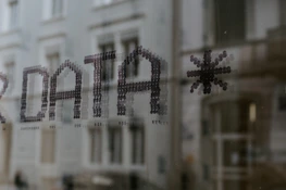 The word DATA and a star symbol stenciled in dark dots on glass