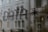 Text formed by small dots spelling the word 'DATA' followed by an asterisk, seen on a glass surface with a blurred building in the background.