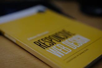 a yellow book sitting on top of a wooden table