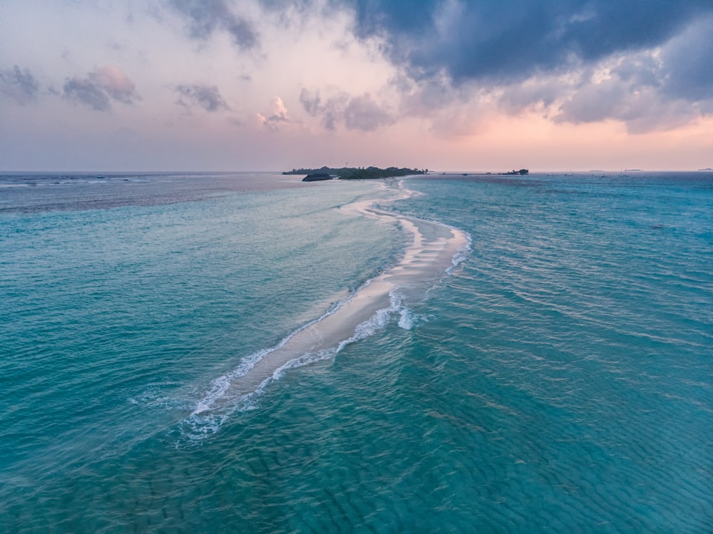 a body of water with a small island in the distance