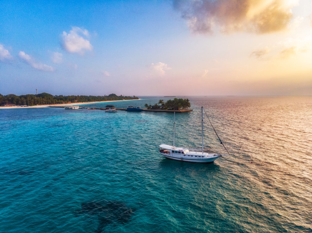 a small boat floating on top of a large body of water