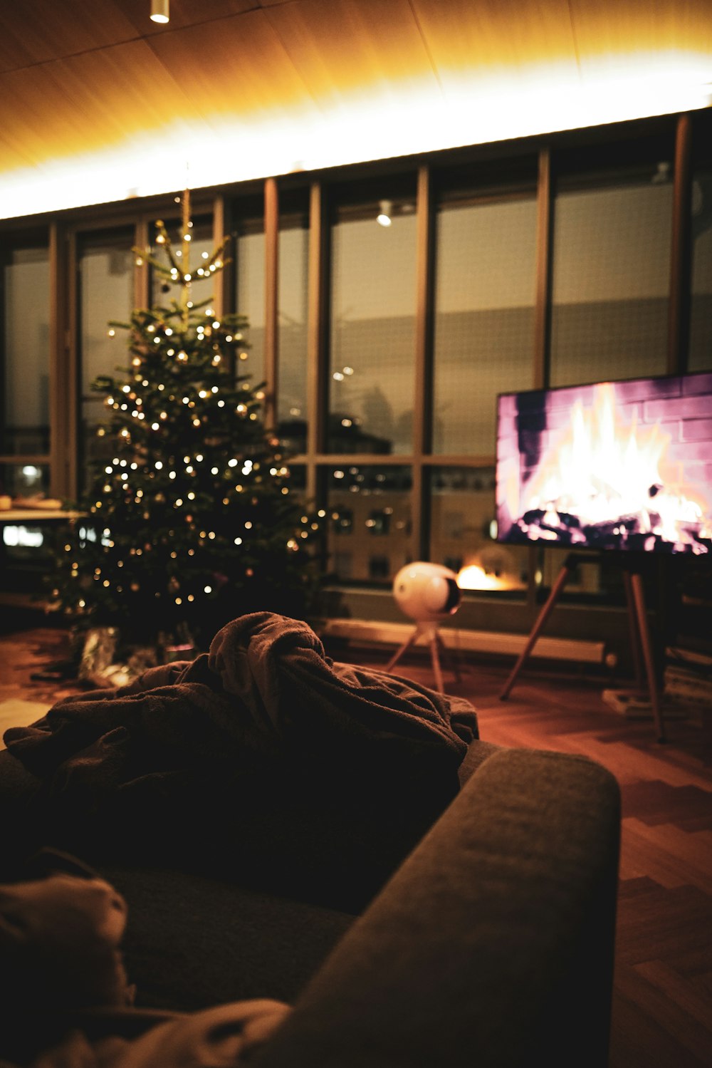 a living room filled with furniture and a christmas tree