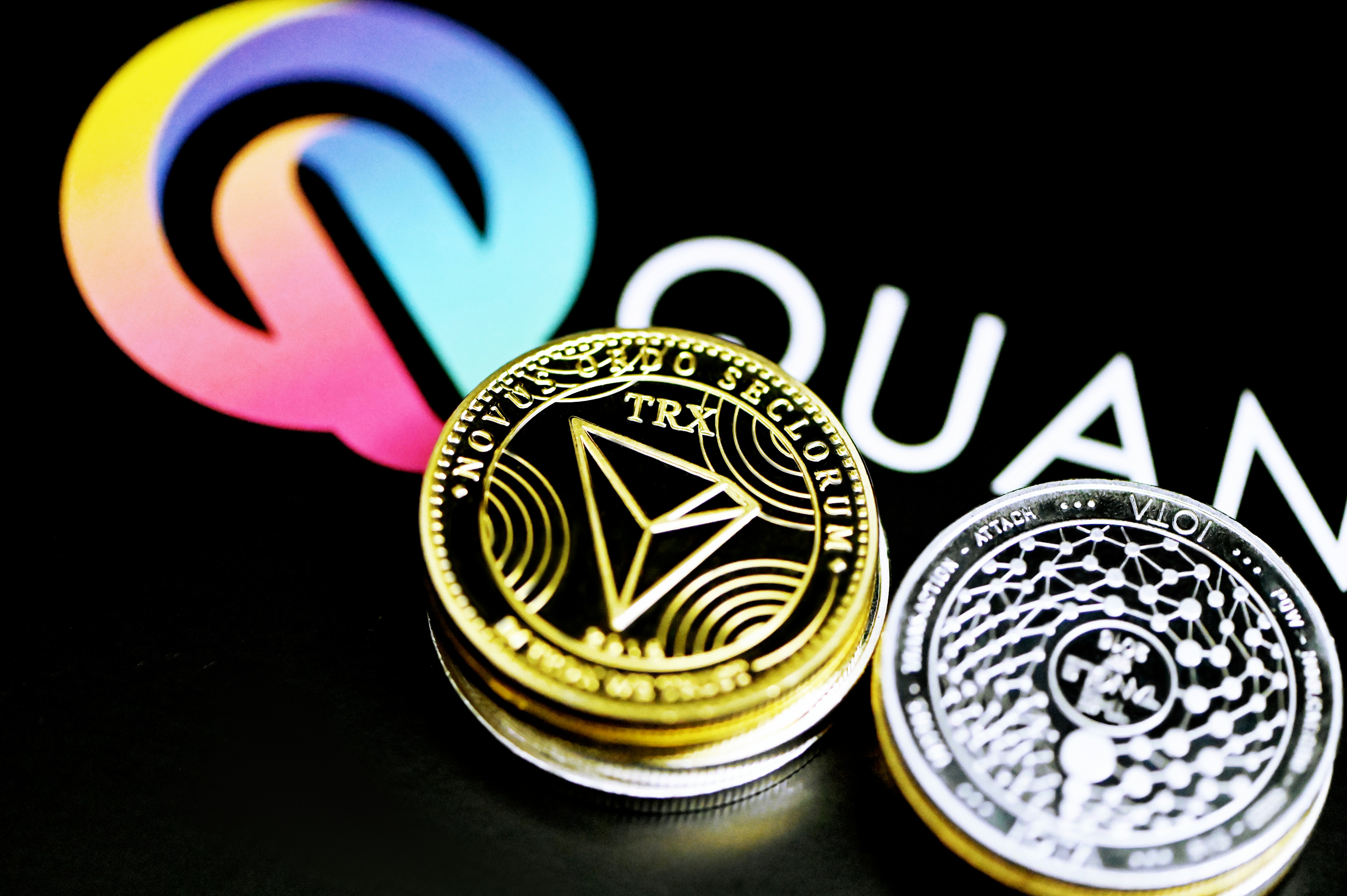Tron coin and IOTA coin are together on the Quantitatives logo