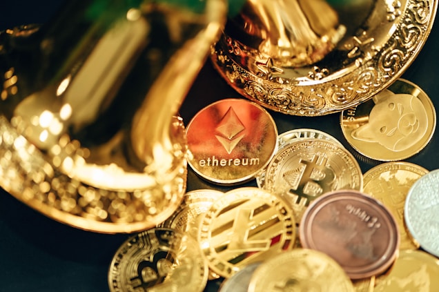 A collection of various cryptocurrency coins are scattered, including prominent ones like Ethereum and Bitcoin, surrounded by decorative golden objects.
