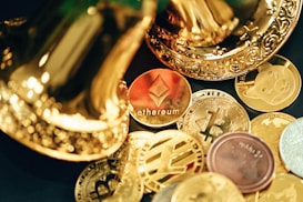 A collection of various cryptocurrency coins are scattered, including prominent ones like Ethereum and Bitcoin, surrounded by decorative golden objects.
