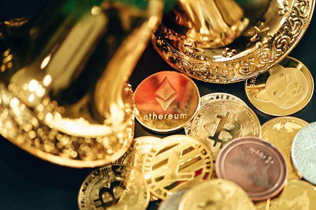 A collection of various cryptocurrency coins are scattered, including prominent ones like Ethereum and Bitcoin, surrounded by decorative golden objects.