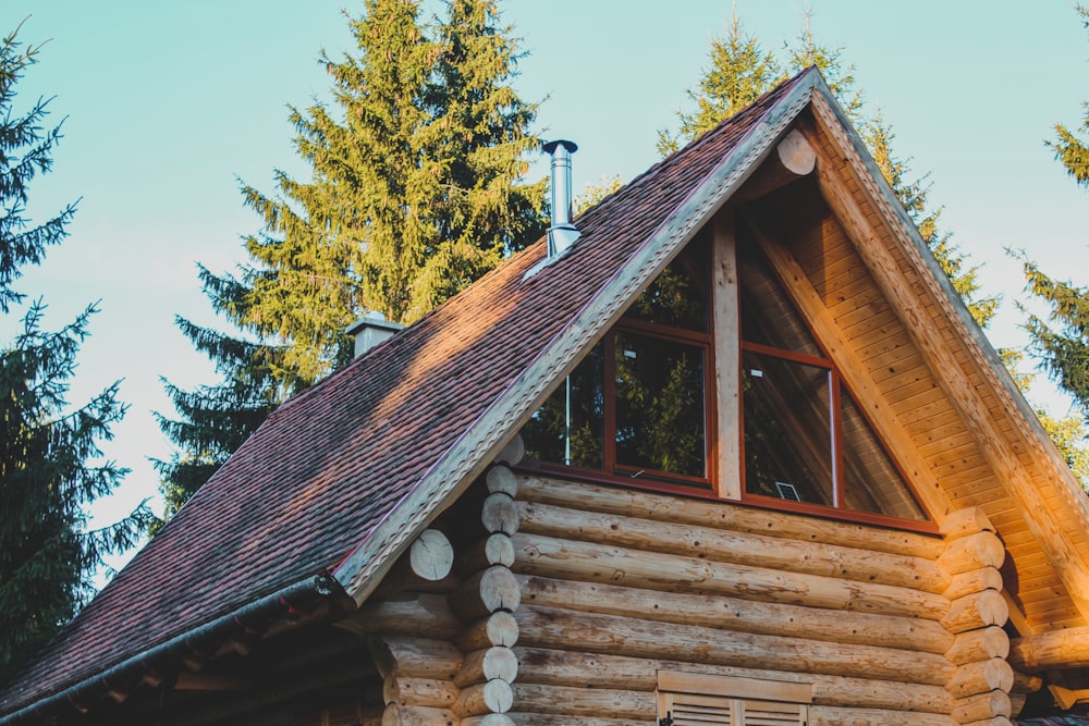 a log cabin with a wooden bench in front of it