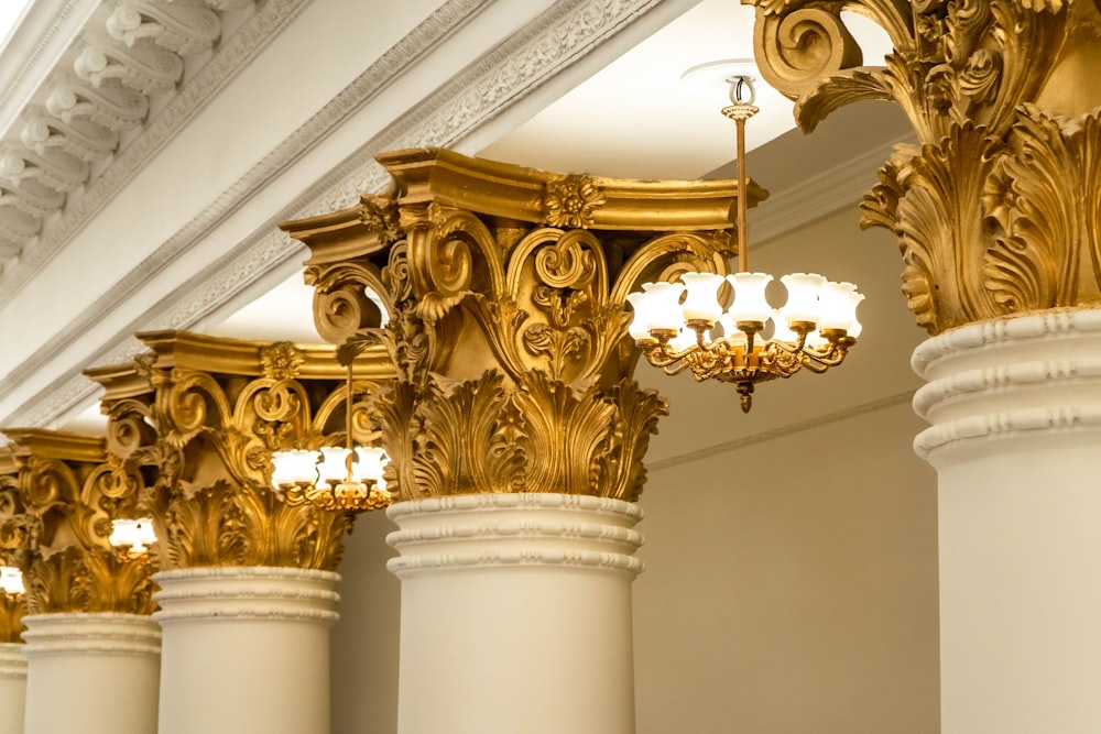 a row of columns with chandeliers hanging from them