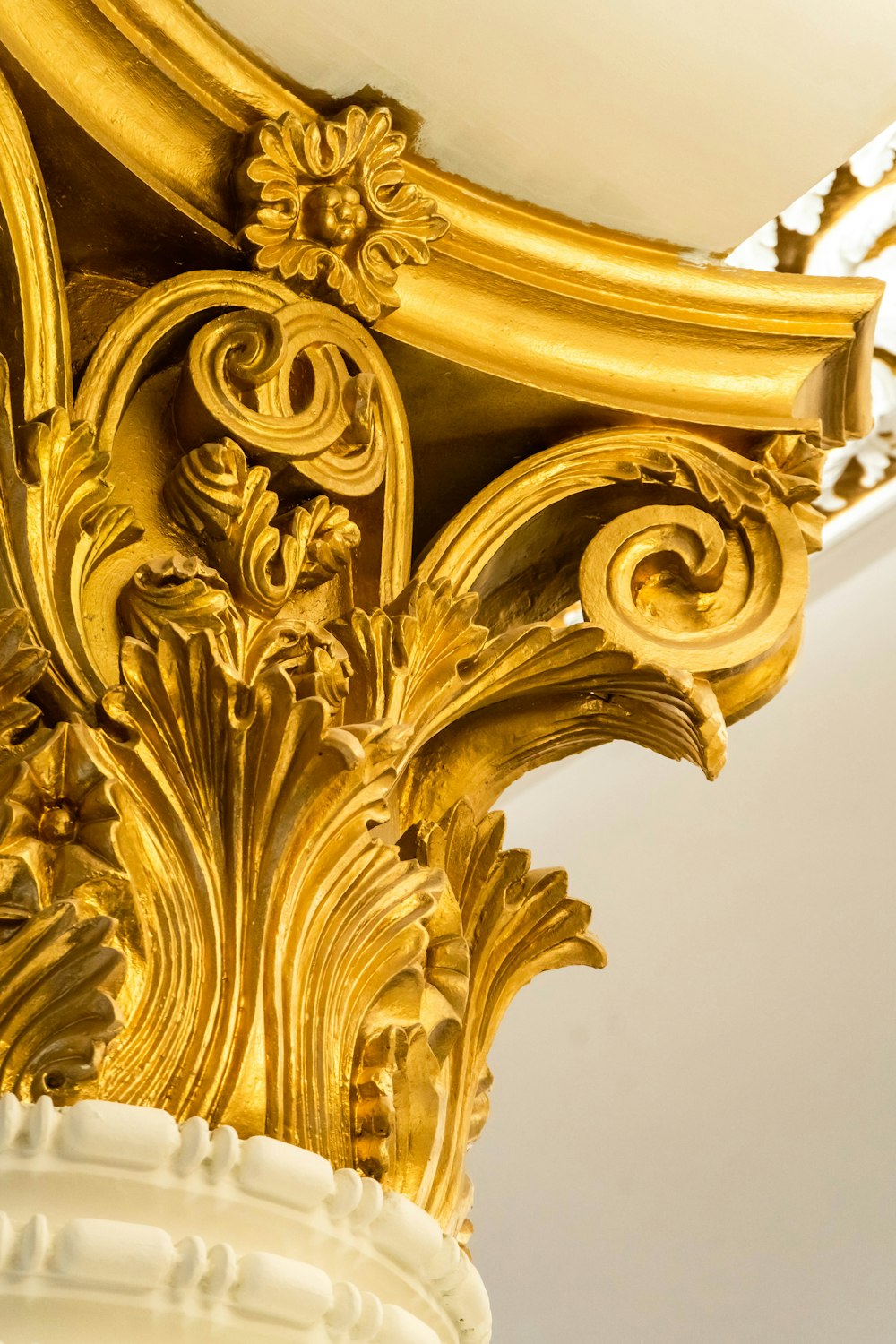 a close up of a gold and white vase