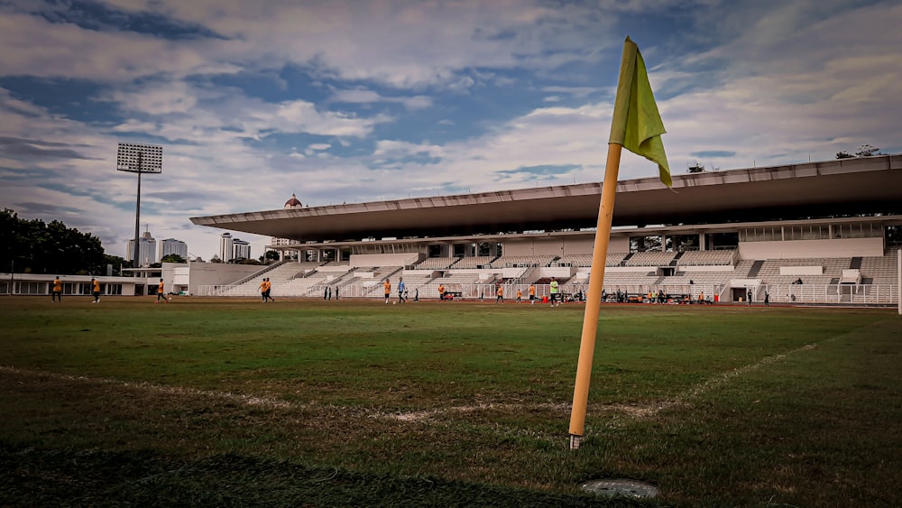 a yellow flag is in the middle of a soccer field