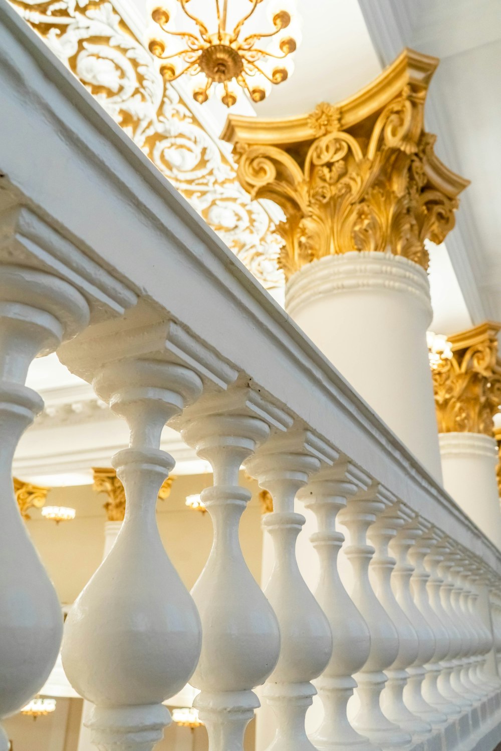 a close up of a white and gold railing