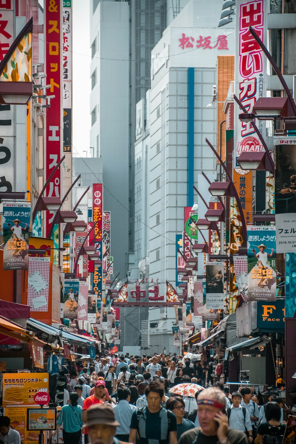 a crowded city street filled with lots of people