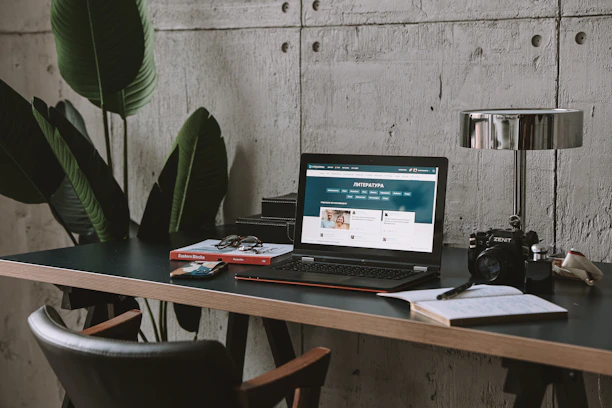 a laptop computer sitting on top of a wooden desk
