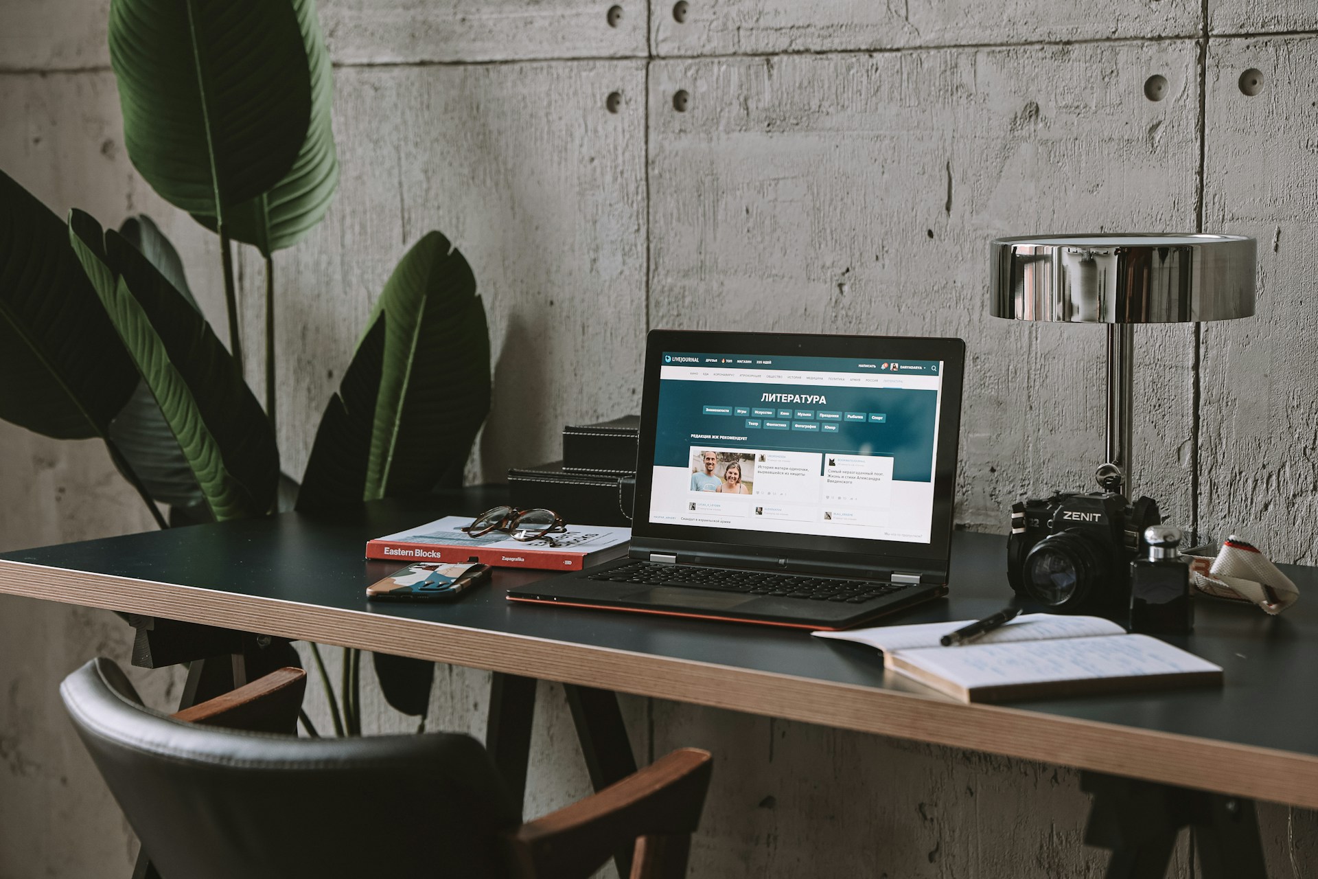 a laptop computer sitting on top of a wooden desk