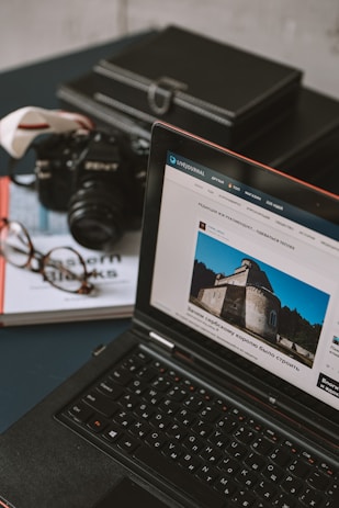 a laptop computer sitting on top of a table