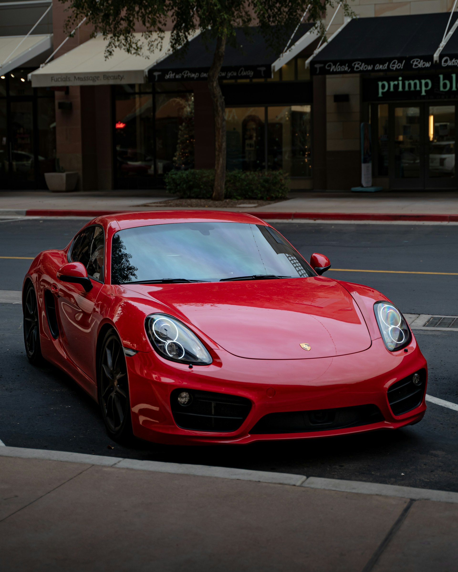 a red sports car parked on the side of the road