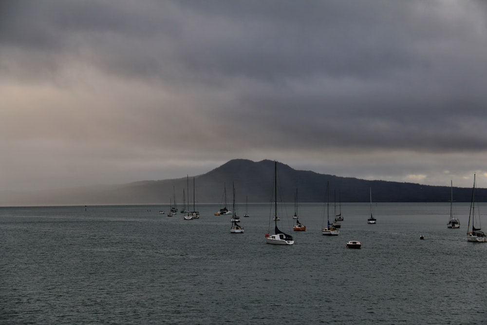 a group of boats floating on top of a large body of water