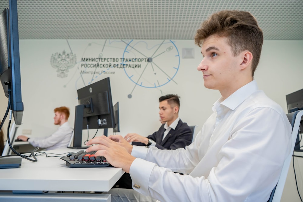 a man sitting at a desk using a computer