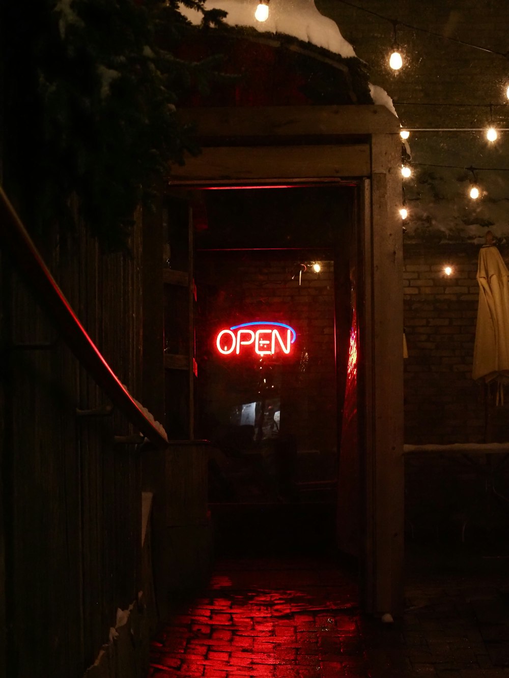 a red open sign is lit up in the dark