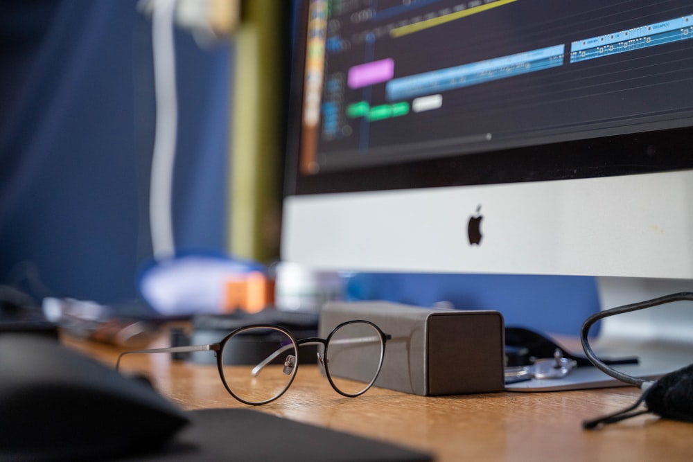 a computer monitor sitting on top of a wooden desk