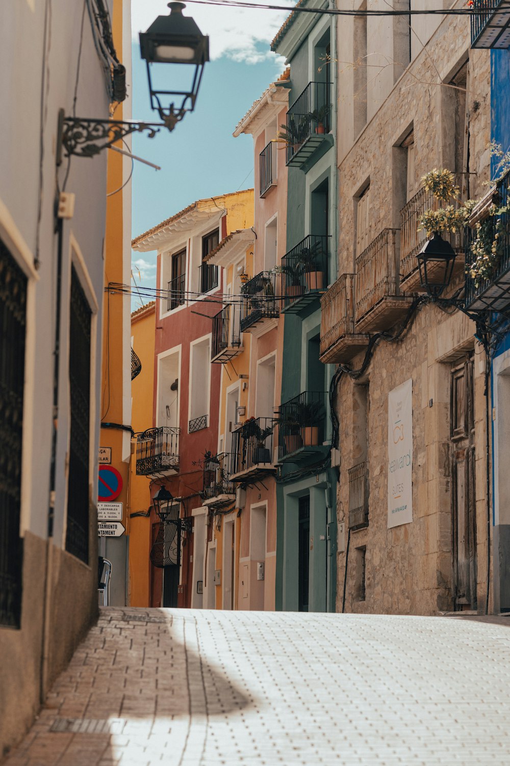 a narrow city street lined with tall buildings