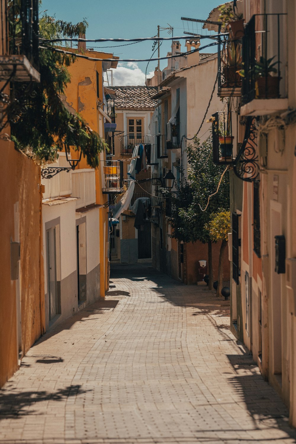 a narrow city street with buildings on both sides