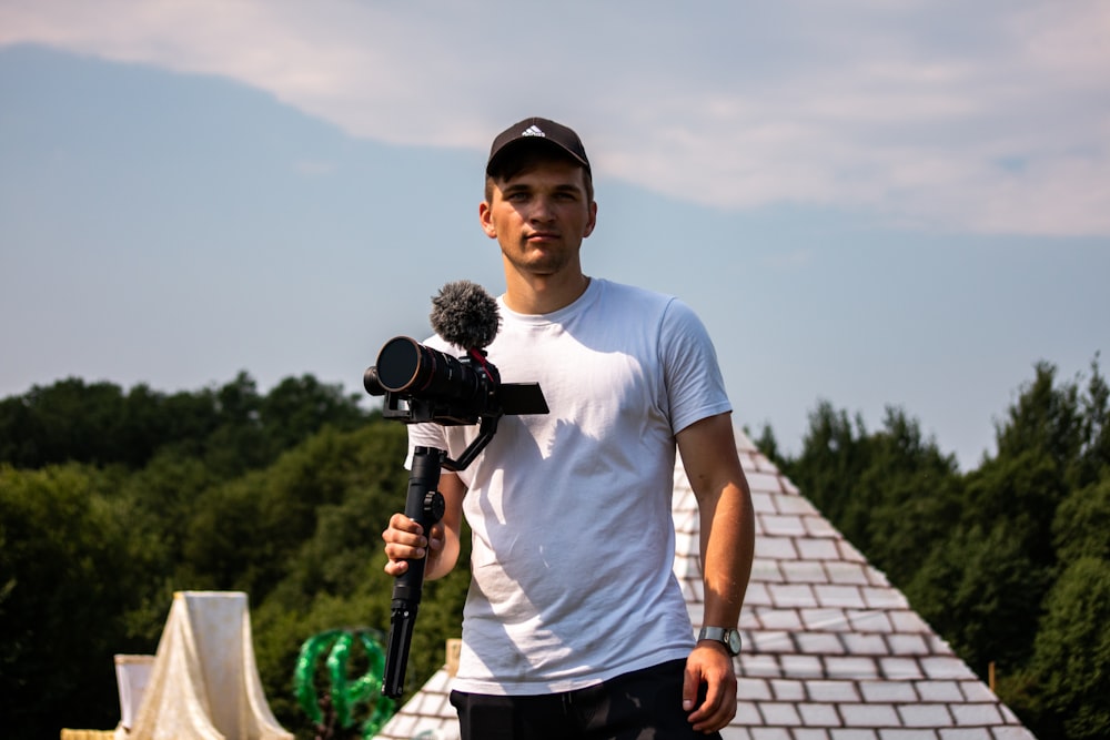a man holding a camera and a microphone