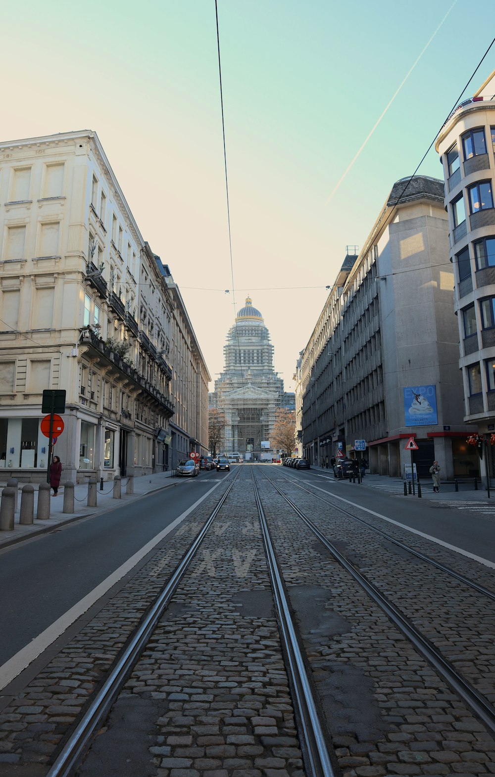 a city street with a train track running through it