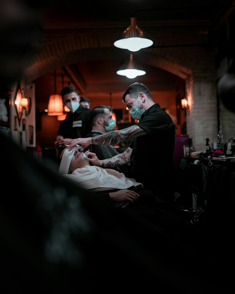 a man getting his hair cut at a barber shop