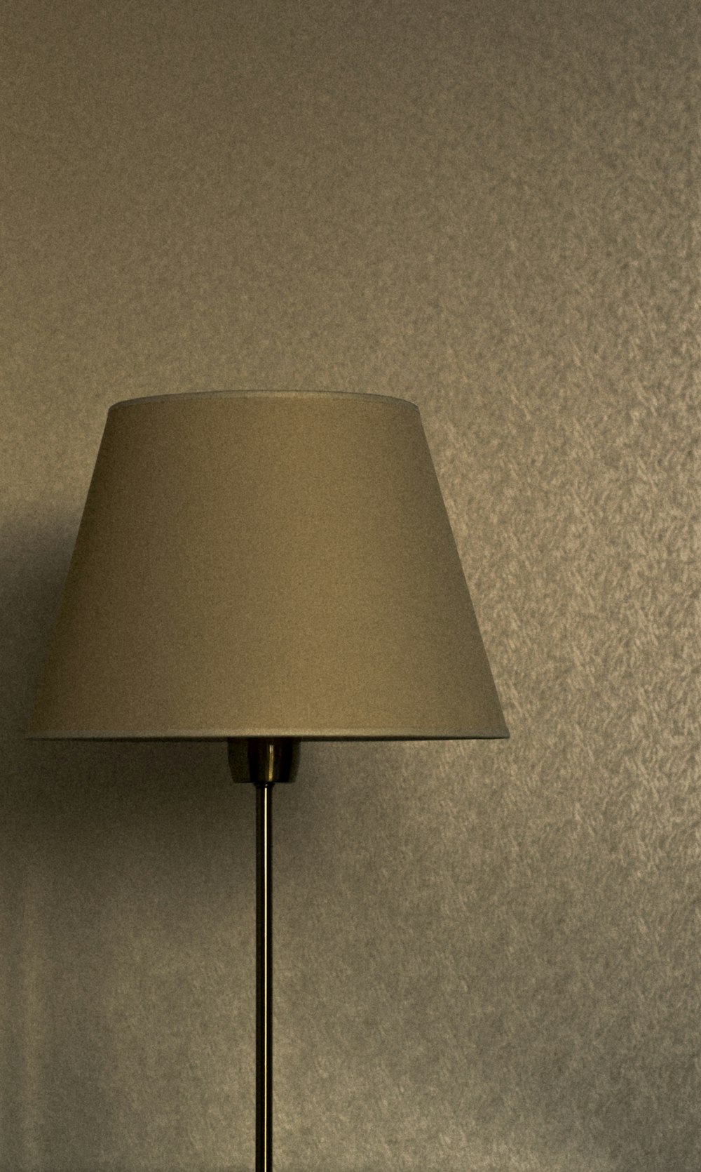a lamp that is on a table next to a wall