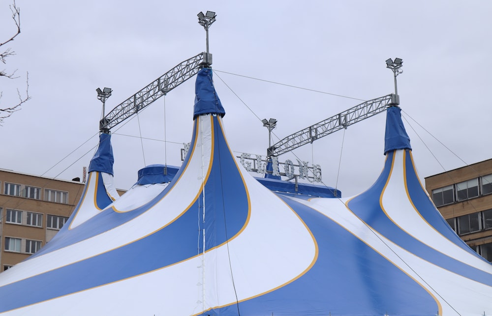 a large blue and white tent with a sky background