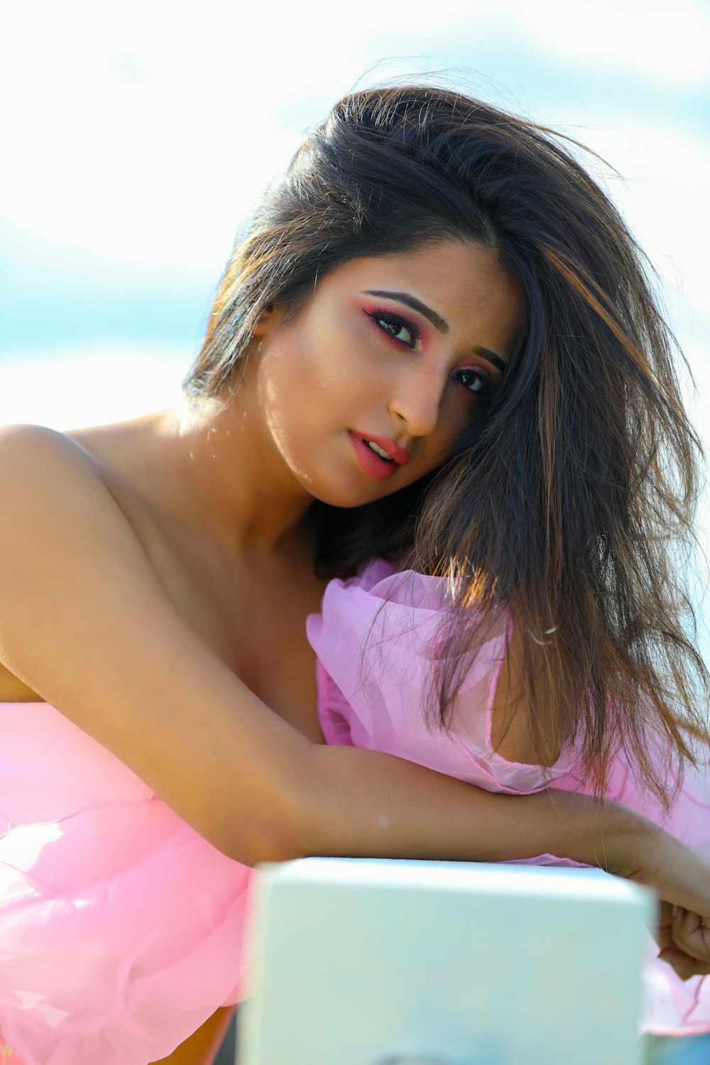 a woman in a pink dress posing for a picture