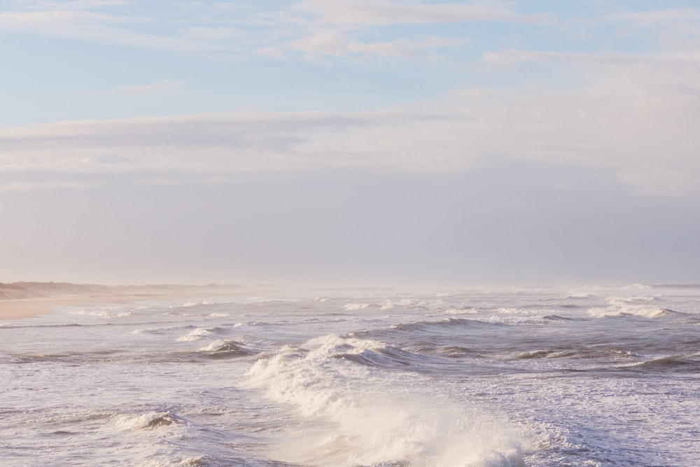 a person riding a surfboard on top of a wave