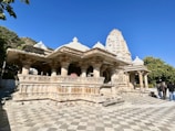 a group of people standing around a stone structure
